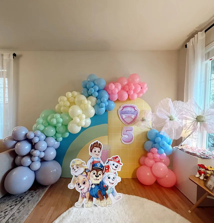 Pastel balloon garland with a character backdrop