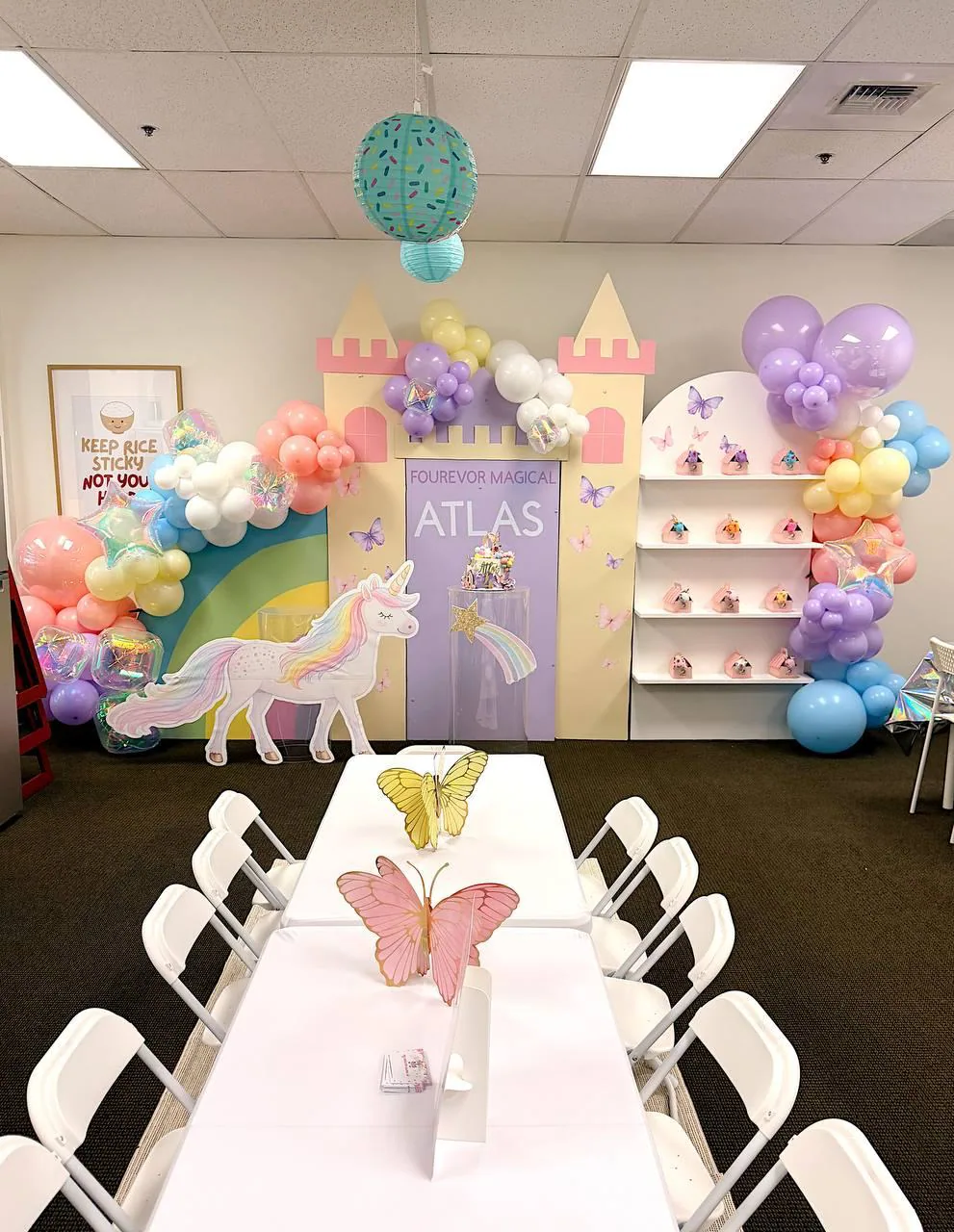 Long party table with a castle backdrop and balloons