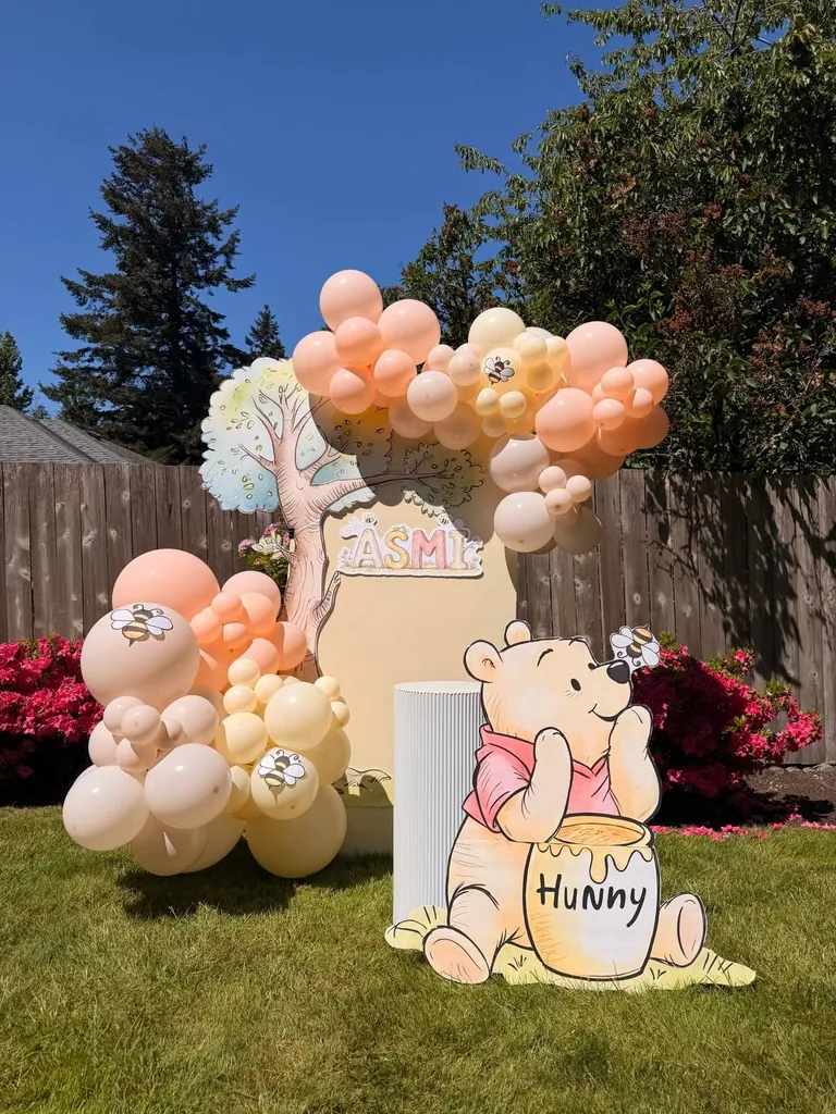 Outdoor balloon arch with a themed cutout