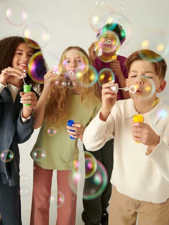 Children blowing bubbles at a party