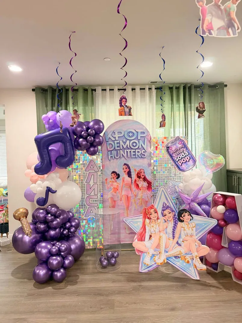 Purple balloon arch and themed party backdrop