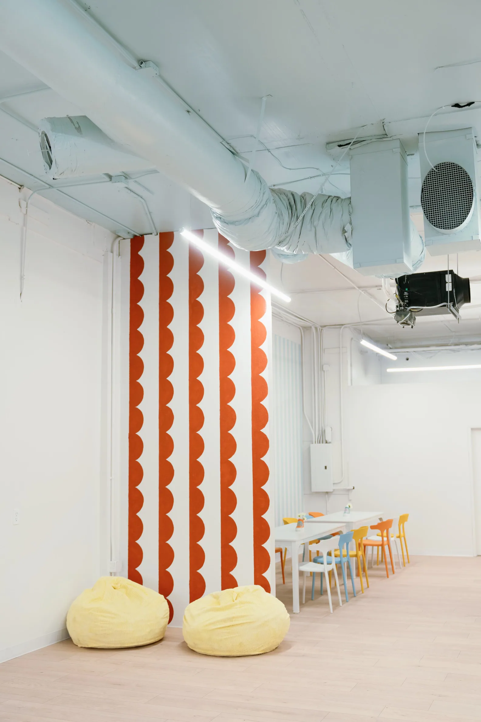 The Lulu party room in Kirkland set with tables and colourful chairs